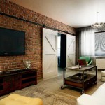 Интерьер 3-комнатной квартиры. Гостиная в стиле лофт. Кирпичная стена и двери купе. Фото