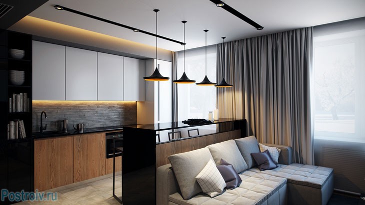 Серый угловой диван в совмещенной кухне с гостиной. Фото